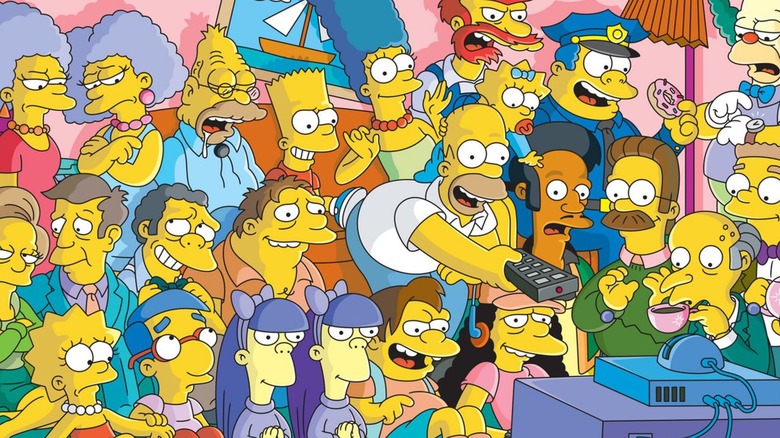 Numerous Simpsons characters sit about the couch as Homer happily uses the remote control in The Simpsons promo artwork