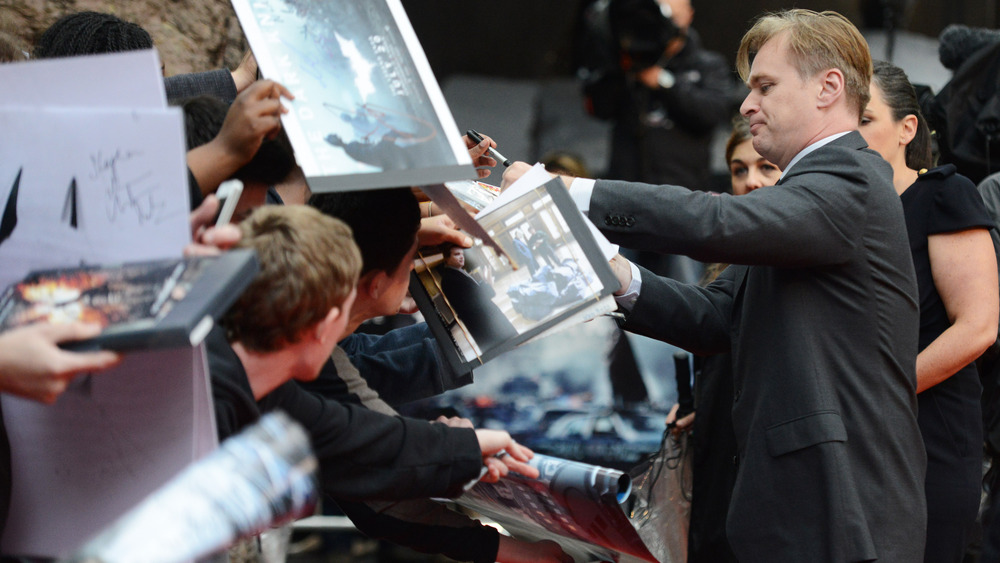 Christopher Nolan signing autographs for The Dark Knight Rises