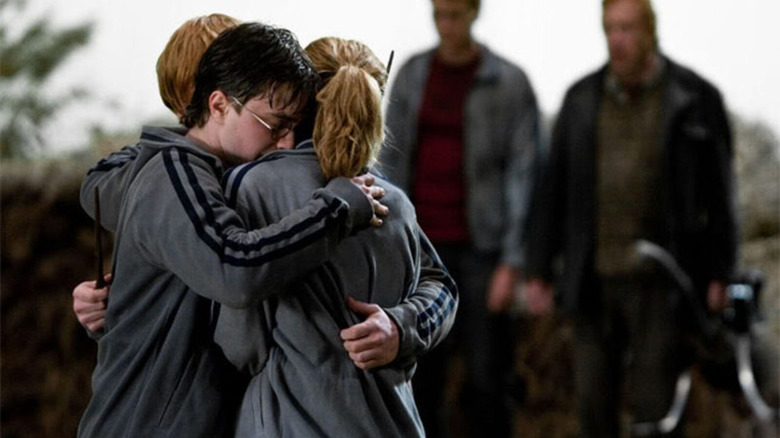 Harry, Ron, and Hermione hugging