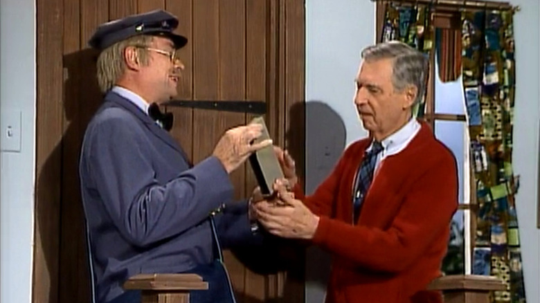 Mister McFeely brings Mister Rogers a videotape.