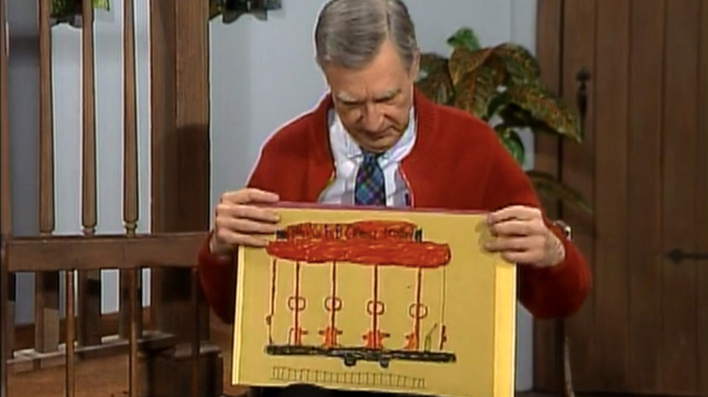 Mister Rogers shows off children's drawings of Trolley.