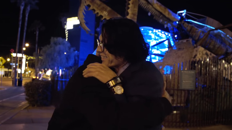 Wiseau and Sestero hugging