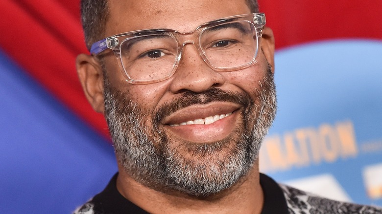 Jordan Peele  smiles in glasses