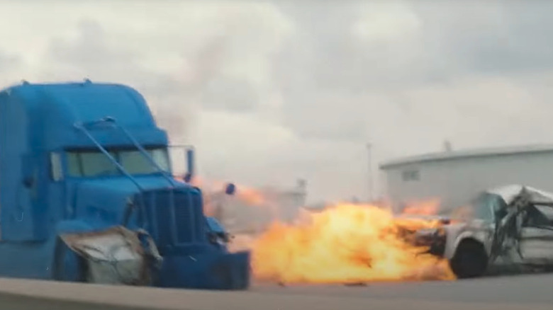 A blue truck smashes a car