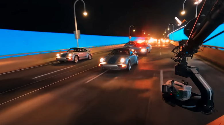 A car chase in front of blue screen