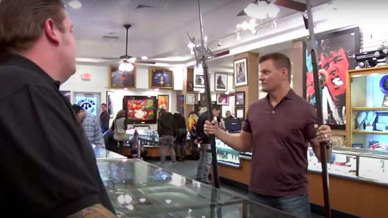 Man holding two halberds on Pawn Stars