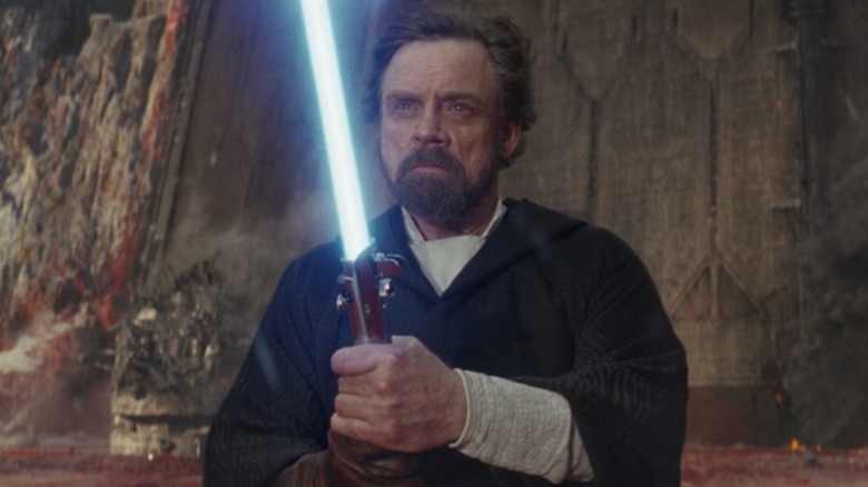 Luke Skywalker holding his lightsaber