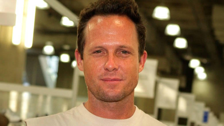 Dean Winters smiles, white t-shirt