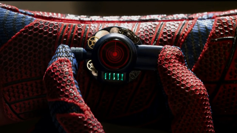 Spider-Man prepares his web shooter