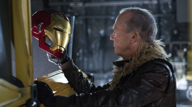 Adrian Toomes holds Iron Man's helmet