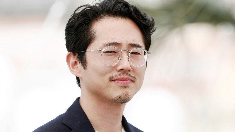 Steven Yeun wearing glasses