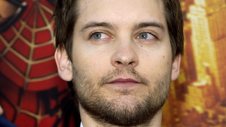 Tobey Maguire in front of poster