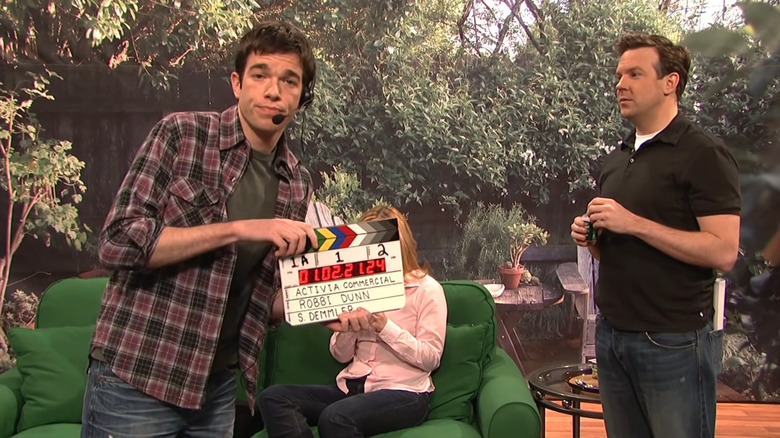 John Mulaney holding clapperboard