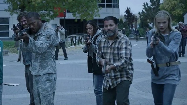 Rose's group of survivors pointing their guns