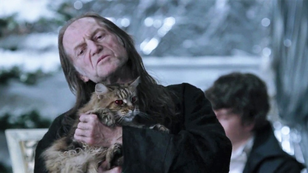 Argus Filch holding cat