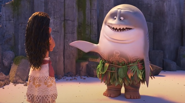 Moana looks on as Maui transforms his top half into a shark