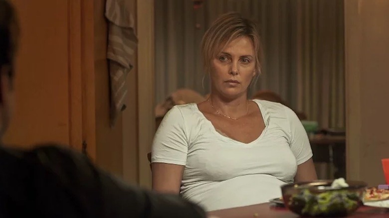 Theron sitting at dinner table in 'Tully'