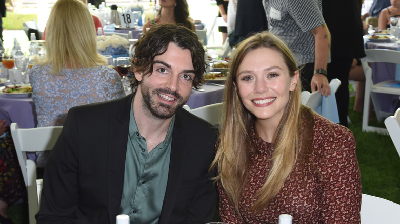 Arnett and Olsen smiling at a luncheon 