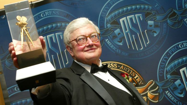 Roger Ebert posing with an award