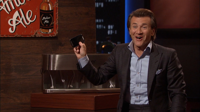 Robert Herjavec holds up phone