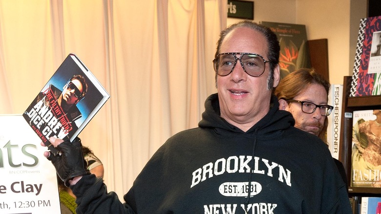 andrew dice clay holding his book