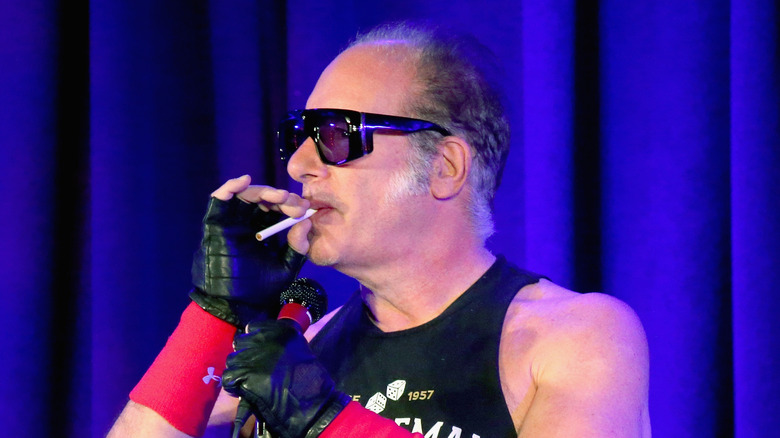 andrew dice clay performing stand-up with cigarette