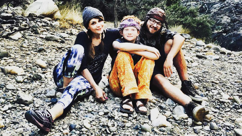 Angus T. Jones, his mother Karey, and brother Otto sitting on a mountain in 2016