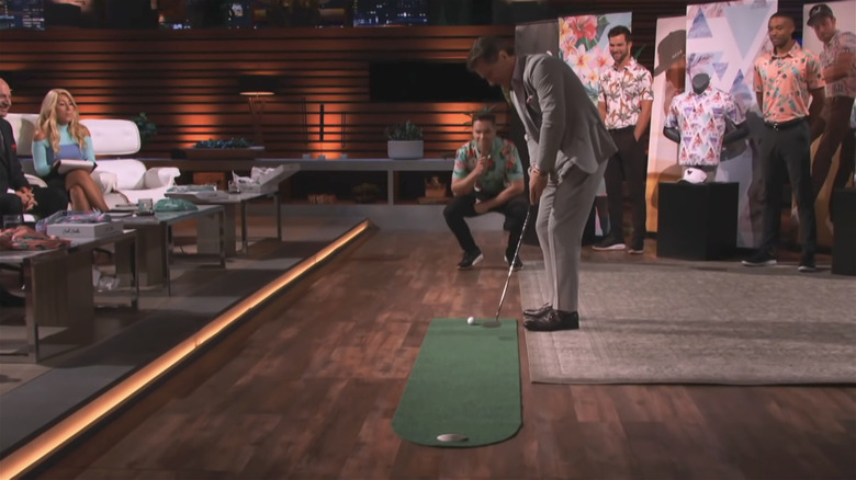 Robert Herjavec trying to sink a putt