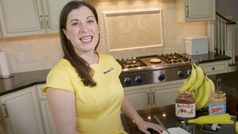 Woman in kitchen yellow shirt