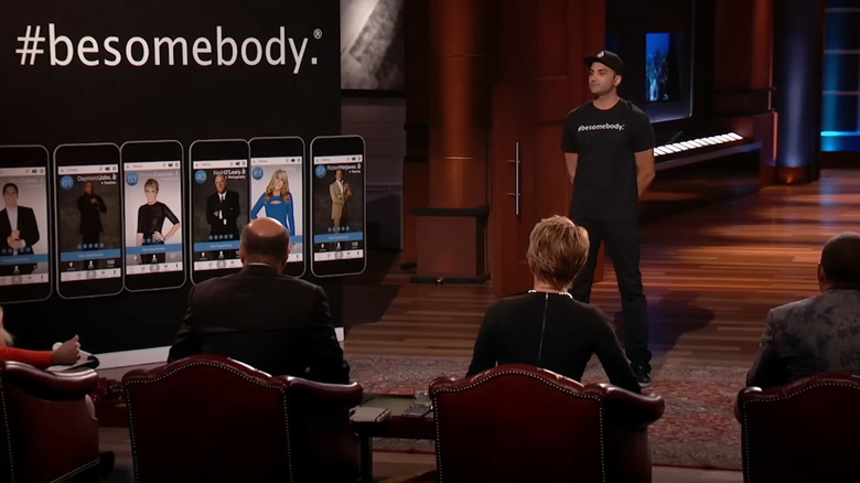 Kash Shaikh standing next to #besomebody display