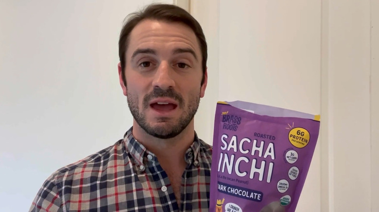 Aaron holding bag of Sacha Inchi seeds