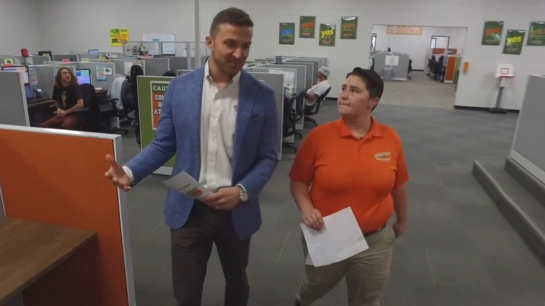 Nick walking with employee