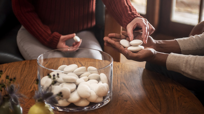 Two people holding Parting Stones