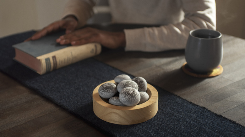 Person sitting with Parting Stones