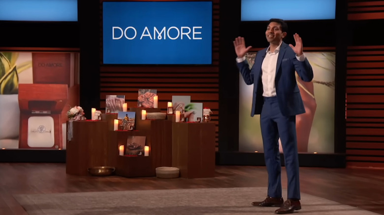 Krish presenting next to Do Amore display