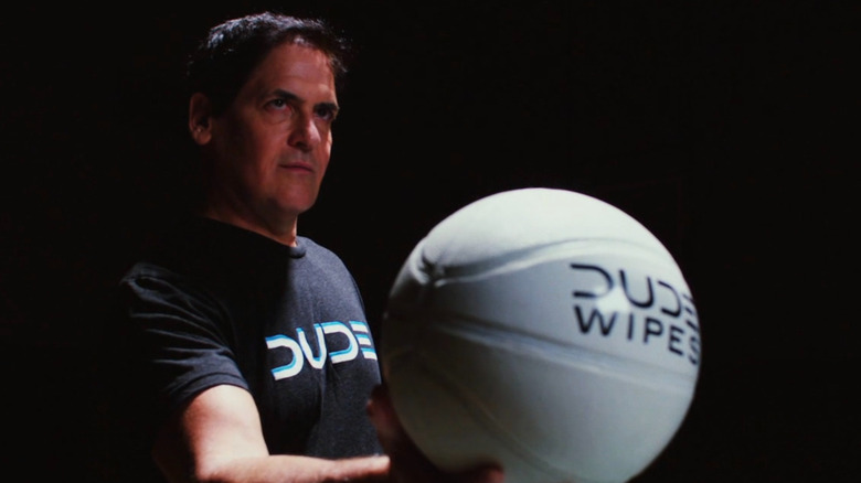 Mark Cuban holding Dude Wipes basketball