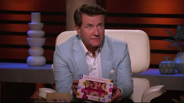 Robert Herjavec holding Eat Your Flowers box