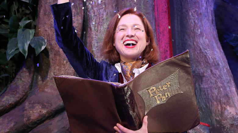 Ellie Kemper holding a book for Peter Pan Goes Wrong on Broadway