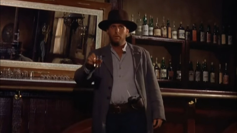 Cowboy standing at a bar