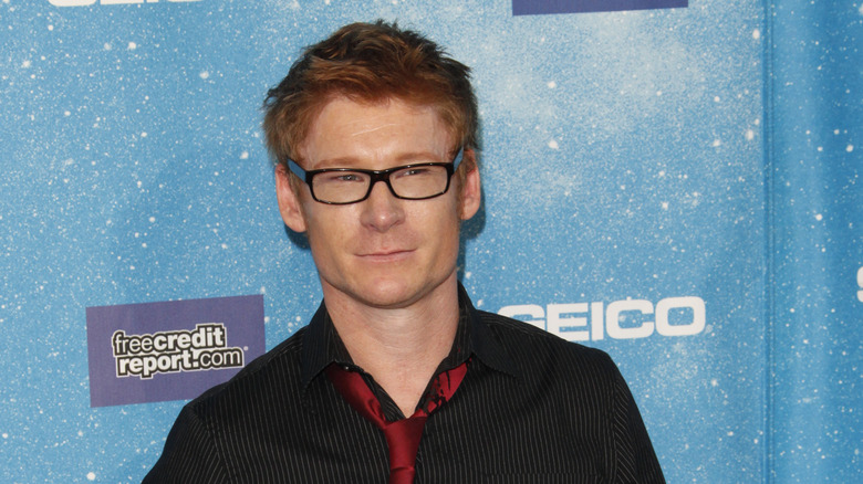 Zack Ward in front of blue poster