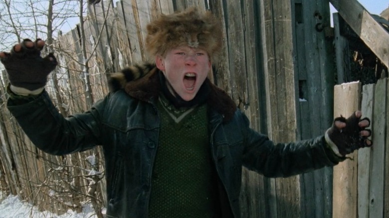 Scut Farkus beside a fence