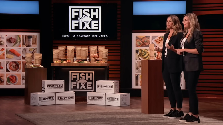 Melissa and Emily presenting next to Fish Fixe display