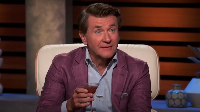 Robert Herjavec holding cocktail glass