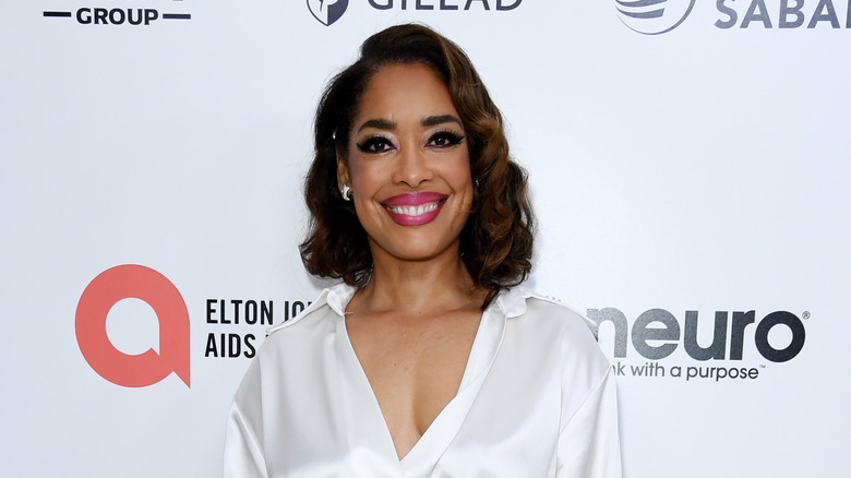 Gina Torres smiles and poses