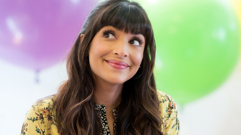 Hannah Simone looks to side