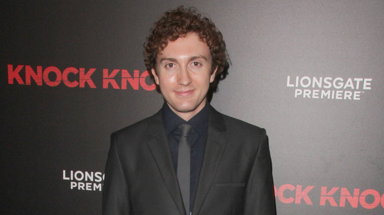 Daryl Sabara smiles wearing suit