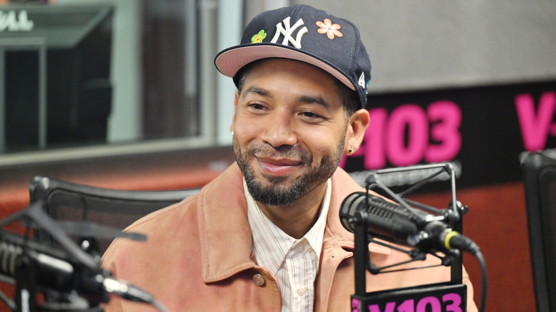 Jussie Smollett smiling while being interviewed for the radio