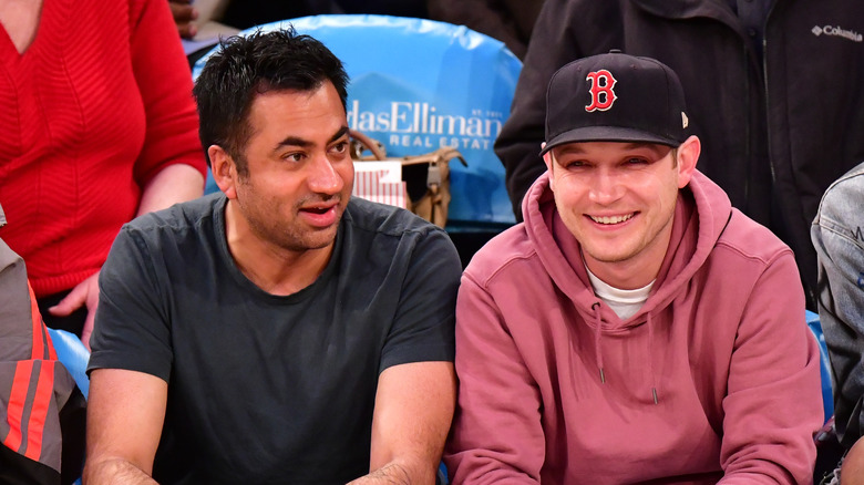 Kal Penn watching game with partner 