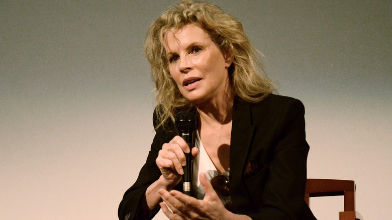 Kim Basinger speaking into microphone