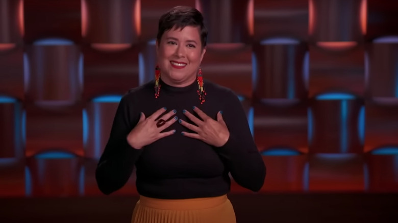 Sandra Velasquez smiling with hands on chest